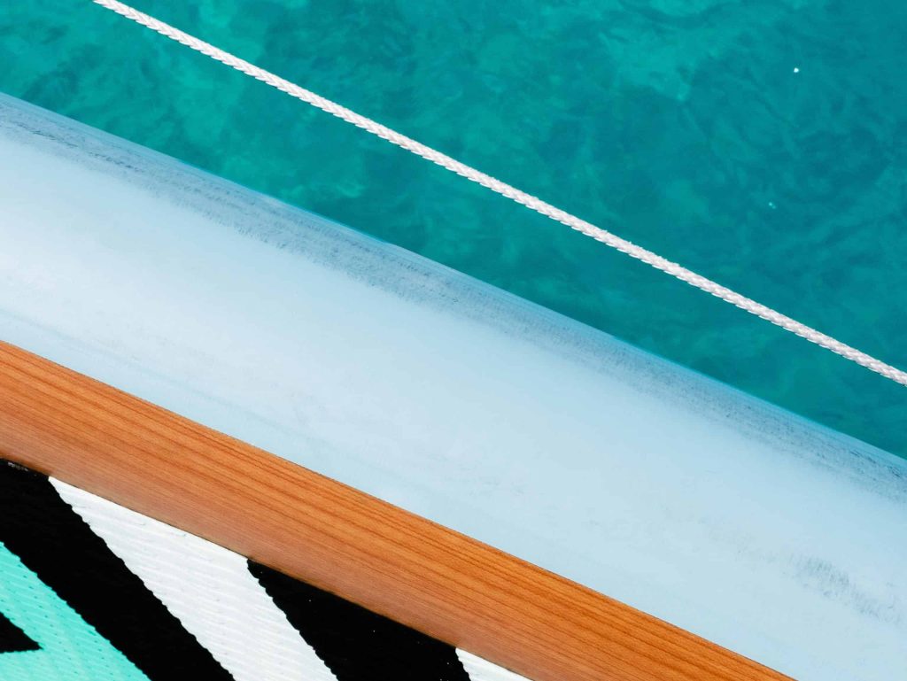 Luxury yacht deck with ocean view and clear blue water.
